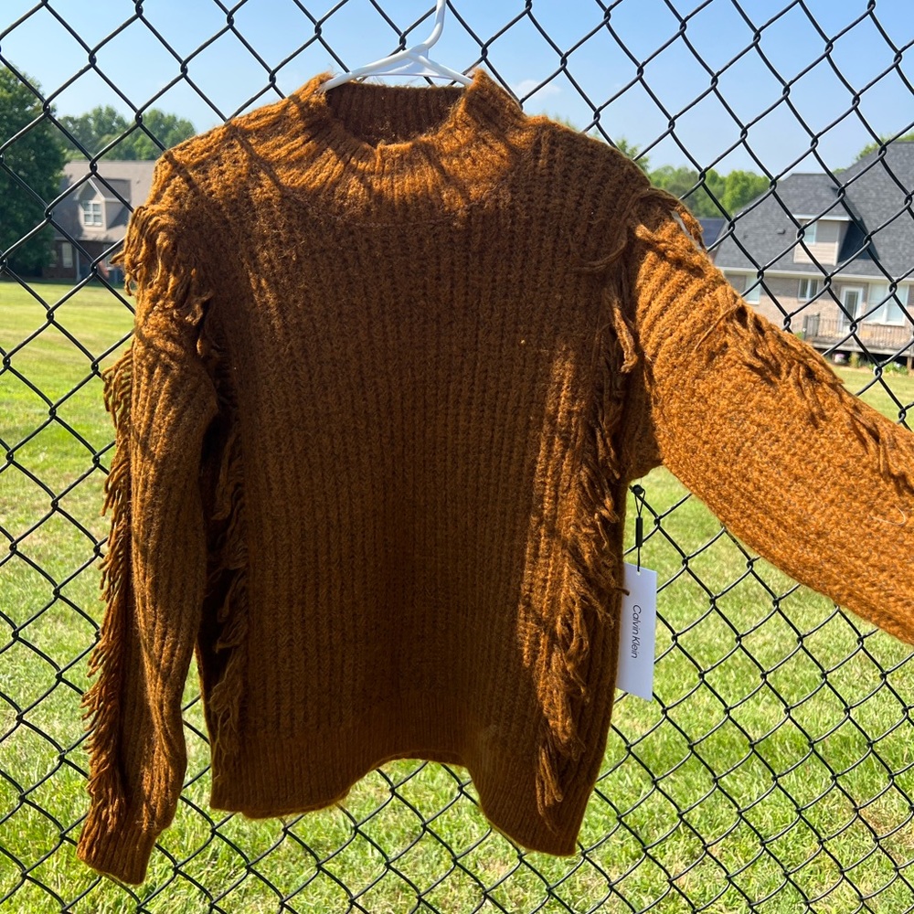 Calvin Klein brown sweater with fringe pieces in size large. NEW WITH TAGS!